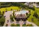 Aerial view of neighborhood pool with clubhouse, lounging and playground area at 105 Putters Ct, Durham, NC 27703