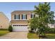 Inviting two-story home featuring a covered front porch, black shutters, and a two-car garage at 105 Putters Ct, Durham, NC 27703