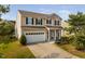 Two-story home showcases a well-manicured lawn, a two-car garage, and inviting curb appeal at 105 Putters Ct, Durham, NC 27703