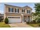 Charming two-story home features a welcoming front porch and a two-car garage at 105 Putters Ct, Durham, NC 27703
