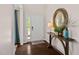 Inviting foyer features a stylish console table with a decorative mirror and dark hardwood floors at 105 Putters Ct, Durham, NC 27703