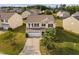 Aerial view of a well-maintained home with a manicured front yard, driveway, and two-car garage at 105 Putters Ct, Durham, NC 27703