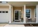 Cozy front porch with white columns, a welcome sign, and view of the front door at 105 Putters Ct, Durham, NC 27703