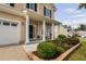 Charming front porch with classic columns, a cozy seating area, and beautiful landscaping at 105 Putters Ct, Durham, NC 27703