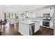 Open concept: White kitchen with granite countertops, island, stainless appliances, flows into the bright living space at 105 Putters Ct, Durham, NC 27703