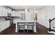 Bright kitchen features white cabinets, an island with seating, stainless steel appliances, and granite countertops at 105 Putters Ct, Durham, NC 27703