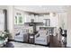 Bright, open kitchen with white cabinetry, stainless steel appliances, and a breakfast bar at 105 Putters Ct, Durham, NC 27703