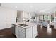 Kitchen island view: Granite countertops, stainless appliances, with open concept to the living room at 105 Putters Ct, Durham, NC 27703