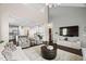 Open-concept living room flowing into the kitchen, with high ceilings and comfortable seating at 105 Putters Ct, Durham, NC 27703