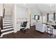 Desk nook beside the stairs and living room featuring dark hardwood floors and vaulted ceiling at 105 Putters Ct, Durham, NC 27703
