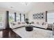 Spacious living room featuring vaulted ceilings, two sofas, and a large round wooden coffee table at 105 Putters Ct, Durham, NC 27703