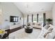 Open concept living room featuring vaulted ceilings, large windows, and comfortable seating at 105 Putters Ct, Durham, NC 27703