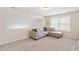 Comfortable upstairs living room featuring a neutral-colored sofa and a cozy seating area at 105 Putters Ct, Durham, NC 27703