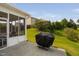 Cozy outdoor patio with a grill and an adjacent screened-in porch, perfect for entertaining at 105 Putters Ct, Durham, NC 27703