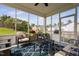 Relaxing sunroom featuring stylish seating, a blue rug, and views of the surrounding landscape at 105 Putters Ct, Durham, NC 27703