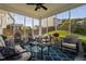 Inviting sunroom with comfortable seating, a ceiling fan, and serene backyard views at 105 Putters Ct, Durham, NC 27703