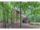 Side angle of the home highlighting the expansive backyard, deck, and wooded surroundings at 105 Trailwood Ct, Chapel Hill, NC 27516