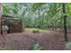 A treed backyard with a wooden deck and stairs descending into the garden at 105 Trailwood Ct, Chapel Hill, NC 27516