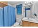 Bathroom featuring a white vanity, large mirror, blue walls, and blue curtain at 105 Trailwood Ct, Chapel Hill, NC 27516