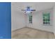 This bedroom features bright white walls, two windows, and a ceiling fan at 105 Trailwood Ct, Chapel Hill, NC 27516