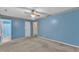 This bright bedroom has light blue walls, ceiling fan, and doorway to the bath at 105 Trailwood Ct, Chapel Hill, NC 27516