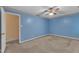 This spacious bedroom features light blue walls and a ceiling fan at 105 Trailwood Ct, Chapel Hill, NC 27516
