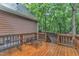 Inviting wooden deck featuring outdoor furniture overlooking the tranquil, wooded backyard and mature trees at 105 Trailwood Ct, Chapel Hill, NC 27516
