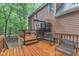 Spacious outdoor deck featuring lounge furniture and a grilling area with picturesque views of the wooded backyard at 105 Trailwood Ct, Chapel Hill, NC 27516