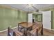 Dining room featuring a wooden table and chairs, neutral carpet, and an open doorway to a living space at 105 Trailwood Ct, Chapel Hill, NC 27516
