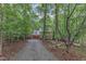 Secluded home nestled in a lush forest setting with a long driveway and mature trees at 105 Trailwood Ct, Chapel Hill, NC 27516