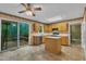 View of the kitchen with wood cabinets, center island, deck access, and stainless steel dishwasher at 105 Trailwood Ct, Chapel Hill, NC 27516