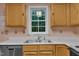 View of the kitchen with light wood cabinets and a stainless steel sink under a bright window at 105 Trailwood Ct, Chapel Hill, NC 27516