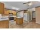 Open kitchen design with wood cabinets, a central island, and modern appliances for convenient meal preparation at 105 Trailwood Ct, Chapel Hill, NC 27516