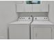Laundry room features a standard white washer and dryer with cabinets above at 105 Trailwood Ct, Chapel Hill, NC 27516
