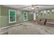 Comfortable living room with large windows, neutral carpet and sofa with access to entryway at 105 Trailwood Ct, Chapel Hill, NC 27516