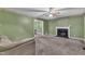 Cozy living room featuring a fireplace, ceiling fan, and neutral-toned walls and carpeting at 105 Trailwood Ct, Chapel Hill, NC 27516