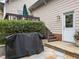 Cozy outdoor space with stone patio and grill, perfect for entertaining at 10579 Evergreen Spring Pl, Raleigh, NC 27614