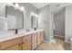 Bathroom featuring double sinks and a shower behind a glass door at 10579 Evergreen Spring Pl, Raleigh, NC 27614