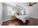 Bright bedroom featuring hardwood floors, a ceiling fan, and a tray ceiling at 10579 Evergreen Spring Pl, Raleigh, NC 27614