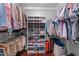 Walk-in closet with built-in shelving and hanging rods at 10579 Evergreen Spring Pl, Raleigh, NC 27614