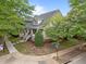 Eye-level corner lot view highlighting mature trees and landscaping, a covered front porch, and charming curb appeal at 10579 Evergreen Spring Pl, Raleigh, NC 27614