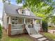 Charming exterior view featuring a covered front porch with white railings, and a inviting staircase at 10579 Evergreen Spring Pl, Raleigh, NC 27614