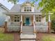 Charming two-story home featuring a welcoming front porch, a bright blue front door, and meticulous landscaping at 10579 Evergreen Spring Pl, Raleigh, NC 27614