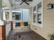 Relaxing covered front porch featuring a ceiling fan and a wooden swing with comfortable cushions at 10579 Evergreen Spring Pl, Raleigh, NC 27614