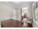 Cozy workspace with desk, chair, dark-stained hardwood floors, and natural light, behind sliding barn door at 10579 Evergreen Spring Pl, Raleigh, NC 27614
