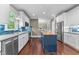 Bright kitchen with white cabinets, blue island, subway tile backsplash, and stainless appliances at 10579 Evergreen Spring Pl, Raleigh, NC 27614
