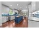 Bright kitchen with blue island, subway tile backsplash, stainless appliances and hardwood flooring at 10579 Evergreen Spring Pl, Raleigh, NC 27614