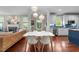Bright, open living space with fireplace and adjacent dining area with large, white table at 10579 Evergreen Spring Pl, Raleigh, NC 27614