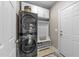 Mud room featuring stacked laundry and storage with a rear door leading to the outside at 10579 Evergreen Spring Pl, Raleigh, NC 27614