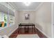 Bright home office with a minimalist design, featuring hardwood floors, large window, and neutral decor at 10579 Evergreen Spring Pl, Raleigh, NC 27614